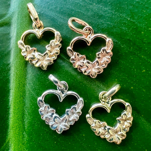 Four small Hawaiian Heart pendants with plumeria flowers in yellow, pink, white and green gold