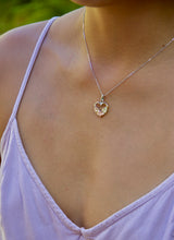 Load image into Gallery viewer, Woman wearing heart shaped Hawaiian Pendant with three plumeria flowers on chain
