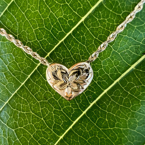 Hawaiian flower in a heart engraved pendant 