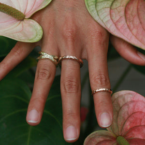 Gold Hawaiian rings on a woman's hand