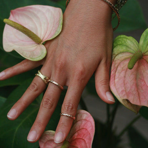 Woman's hand with gold Hawaiian rings