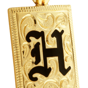 close up engraving detail on Hawaiian Jewelry Initial Pendant with engraving and black enamel 